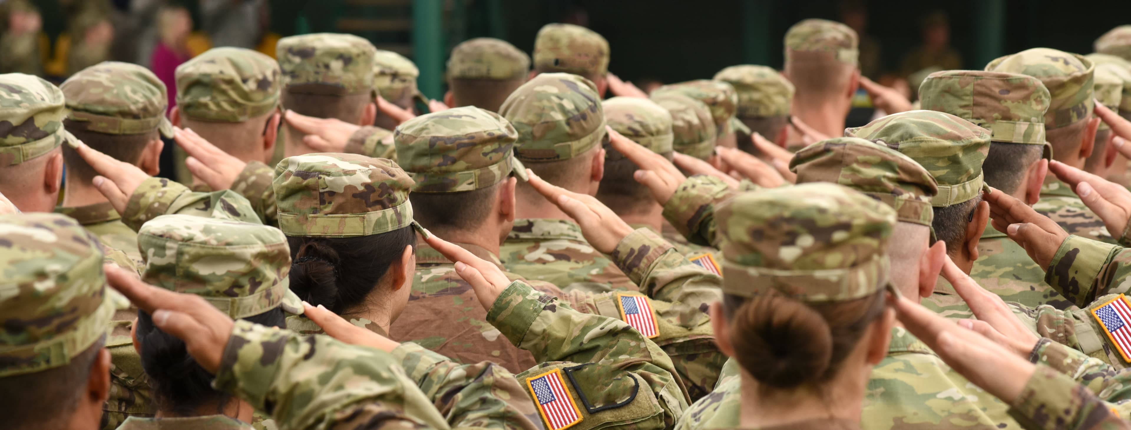 A group of military personnel saluting